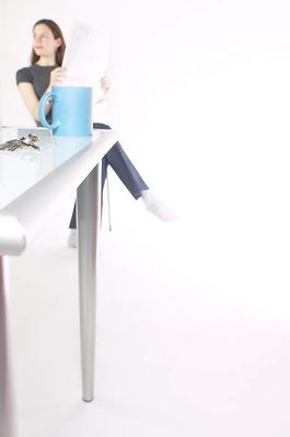 Woman reading newspaper at her desk.jpg