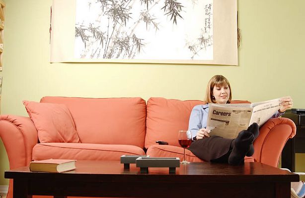 Woman reading newspaper in living room.jpg
