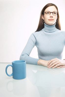 Woman sitting at table with blue coffee mug.jpg