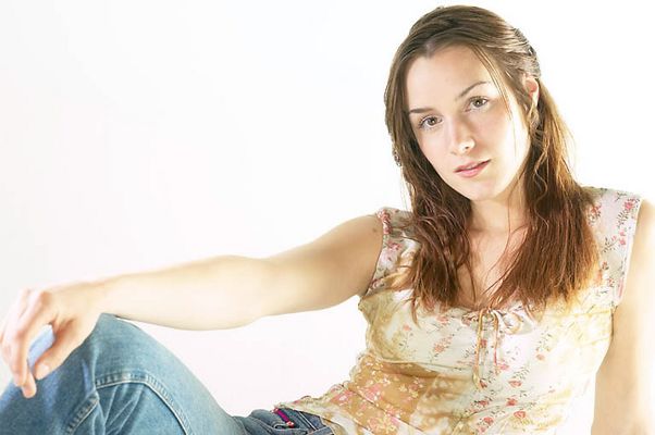 Woman sitting in jeans and floral top a81.jpg