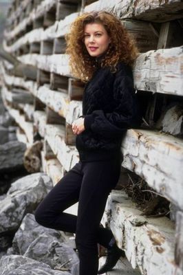 Woman standing against wooden supports.jpg