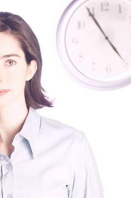 Woman standing in front of clock.jpg