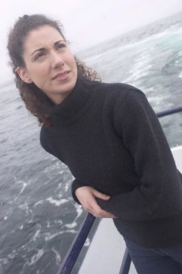 Woman standing on edge of boat uid 1283635.jpg