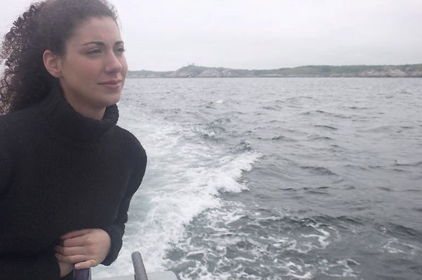 Woman standing on edge of boat uid 1283637.jpg
