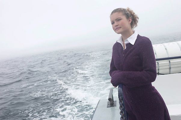 Woman standing on edge of sailboat uid 1283628.jpg