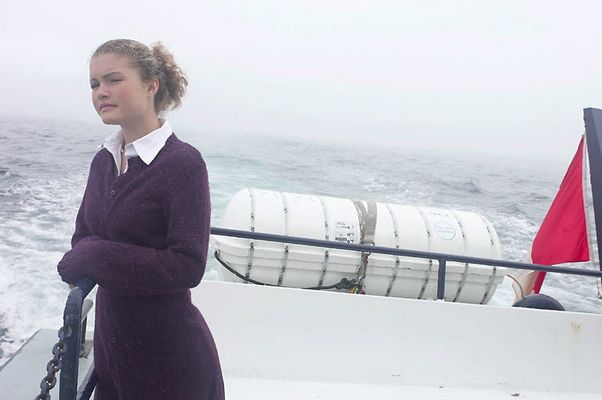 Woman standing on edge of sailboat uid 1283629.jpg