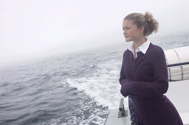 Woman standing on edge of sailboat.jpg
