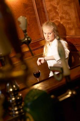 Woman waiting at table in bar c103293.jpg