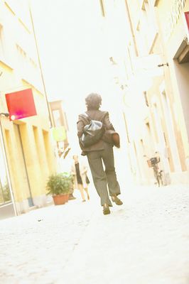 Woman walking away on a sidewalk uid 1455041.jpg