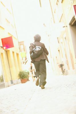 Woman walking away on a sidewalk uid 1455042.jpg