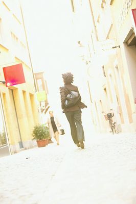 Woman walking away on a sidewalk.jpg
