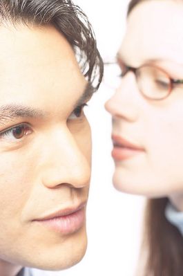 Woman whispering secret into man ear 1.jpg