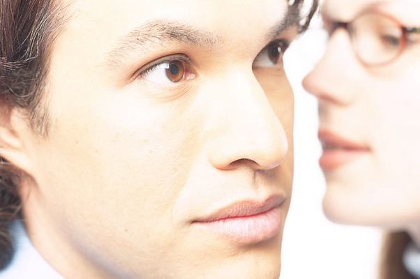 Woman whispering secret into man ear 2 c103124.jpg