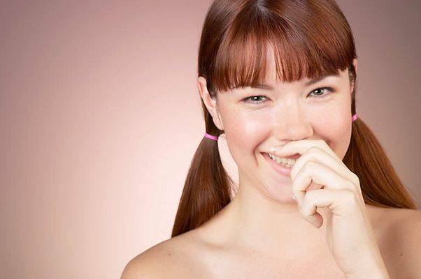 Woman with bare shoulders giggling.jpg