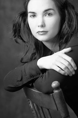 Woman with lip ring sitting in wooden chair 2.jpg