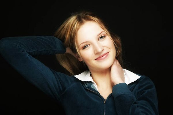 Young blonde woman with a black background uid 1452726.jpg
