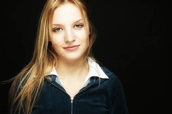 Young blonde woman with a black background uid 1453127.jpg