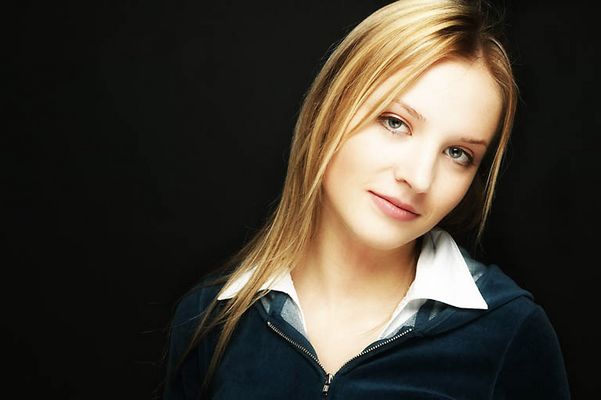 Young blonde woman with a black background uid 1453129.jpg