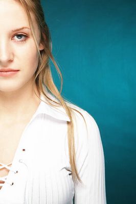 Young blonde woman with a blue background uid 1453103.jpg