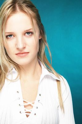 Young blonde woman with a blue background uid 1453105.jpg