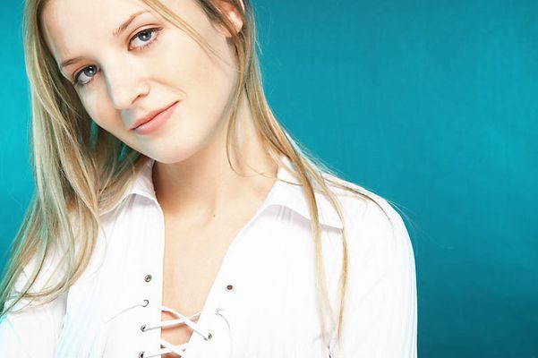 Young blonde woman with a blue background uid 1453111.jpg