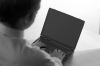 Back of Caucasian businessman typing on black laptop computer.jpg
