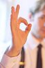 Caucasian businessman giving okay sign.jpg