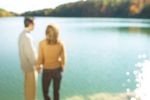 Couple holding hands and looking out at water.jpg