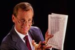 Man in suit with newspaper.jpg