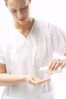 Masseuse pouring massage oil in her hands 2.jpg