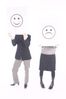 People holding up happy and sad face signs 1.jpg