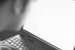 Profile of Caucasian business man typing on black laptop compute.jpg