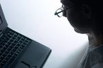 Profile of Caucasian businesswoman using laptop computer.jpg