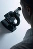 Profile of woman using black microscope.jpg