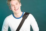 Smiling male adult with shoulder bag uid 1453443.jpg