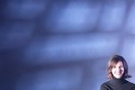 Smiling woman against blue wall.jpg