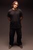 Standing man with long hair wearing black.jpg