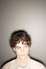 Teenaged boy against gray wall 2.jpg