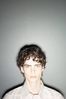 Teenaged boy against gray wall 3.jpg