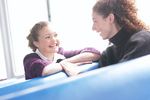 Two smiling women sitting in blue vinyl seats uid 1283663.jpg