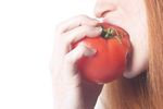 Woman biting tomato uid 1343064.jpg
