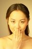 Woman holding hand to mouth uid 1344517.jpg