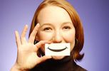 Woman holding paper smile to her face 5.jpg