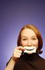 Woman holding paper smile to her face.jpg