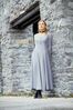 Woman leaning against stone wall.jpg