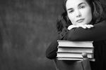 Woman leaning on pile of books 1.jpg