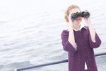 Woman looking through binoculars on boat uid 1283649.jpg
