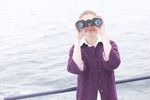 Woman looking through binoculars on boat uid 1283650.jpg