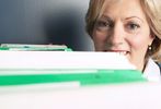 Woman peeking over files.jpg