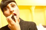 Woman putting on lipstick uid 1433128.jpg